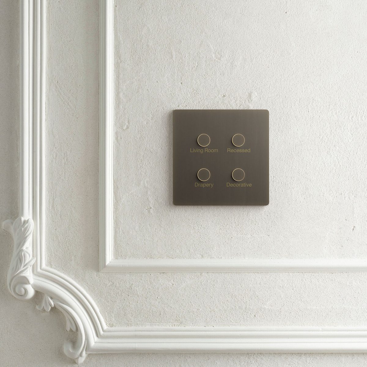 Lutron Alisse keypad in dark bronze mounted on ornate white molding wall