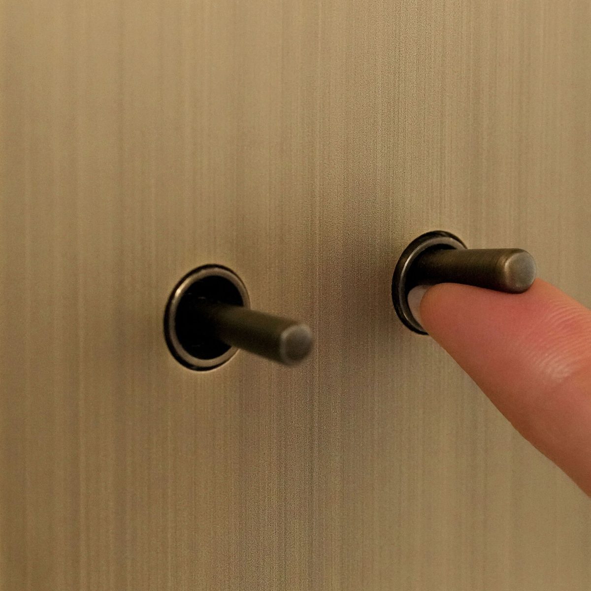 Lutron Avienna toggle keypad close-up in brushed brass finish