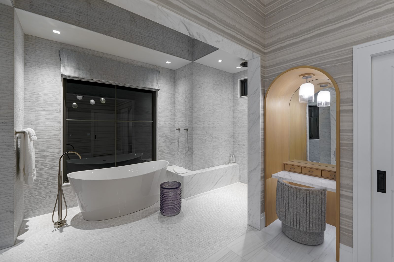 Luxury marble bathroom with recessed lighting controlled by Lutron