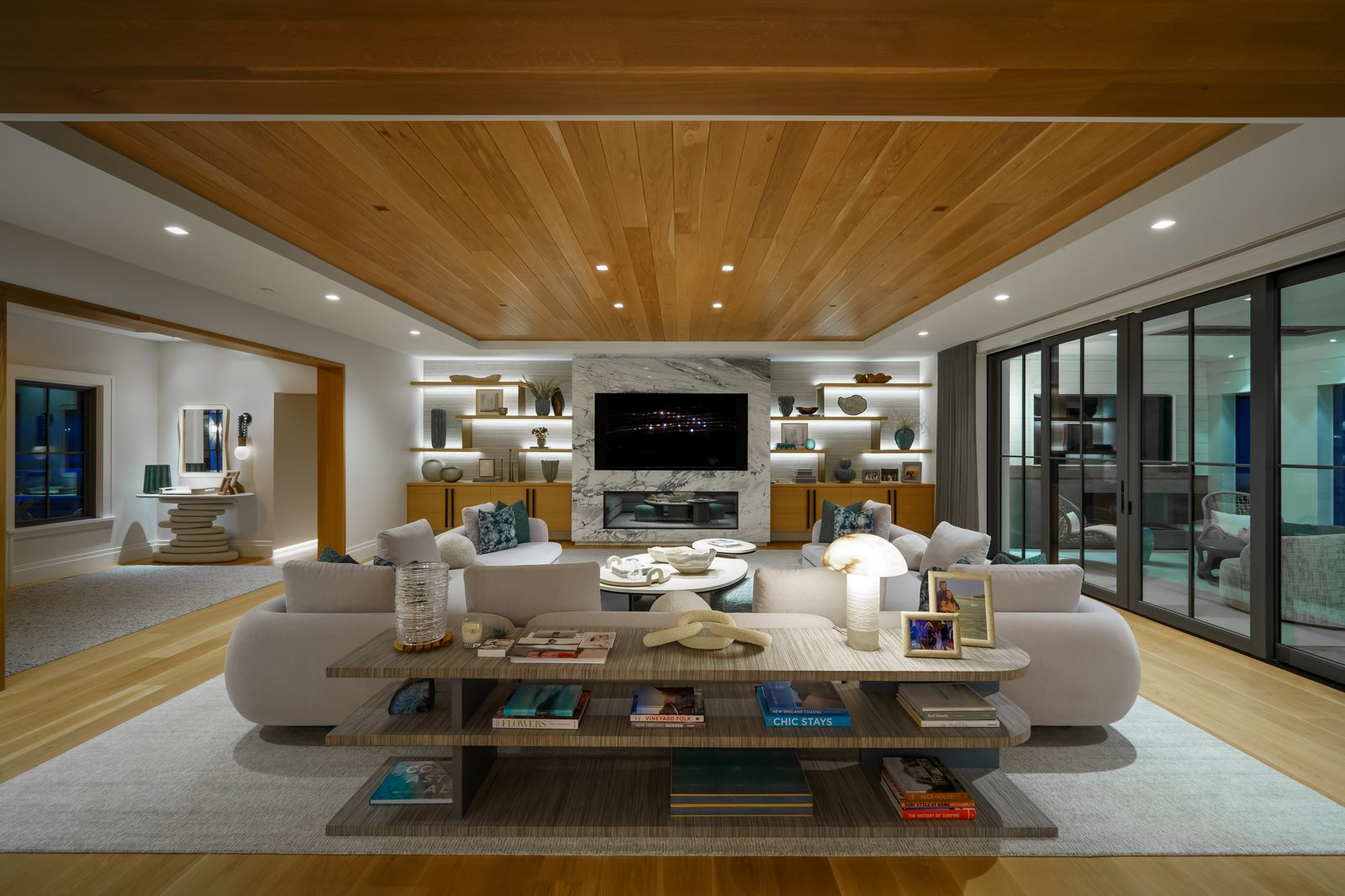 Modern family room with marble fireplace and warm lighting designed by Lutron