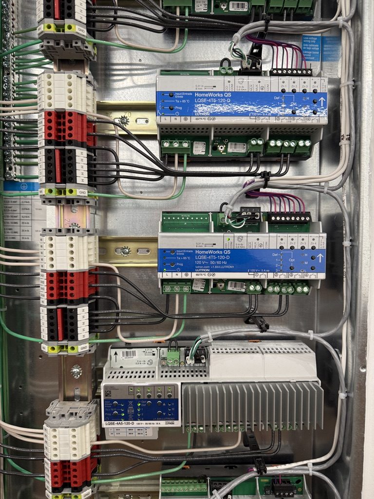 Close-up of Lutron QSX dimming modules with color-coded wiring